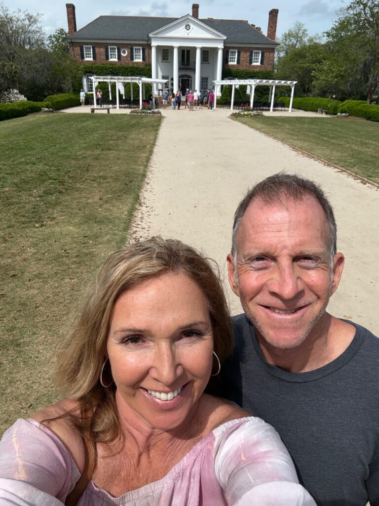 couple standing in front of plantation house