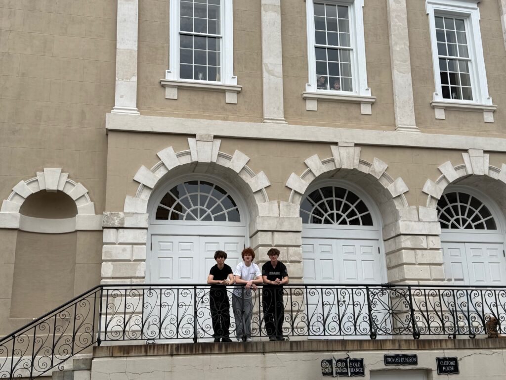 three boys in front of old exchange