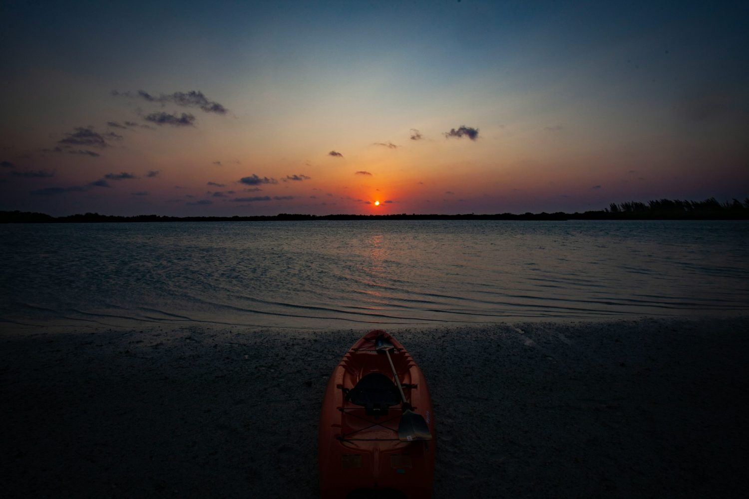 Kayak on a beach at sunset. Florida gulf coast family resorts.