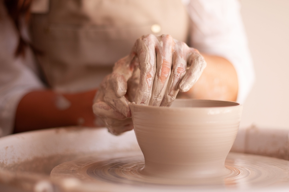 woman creating wheel thrown pot at the Ann Arbor Art Fair