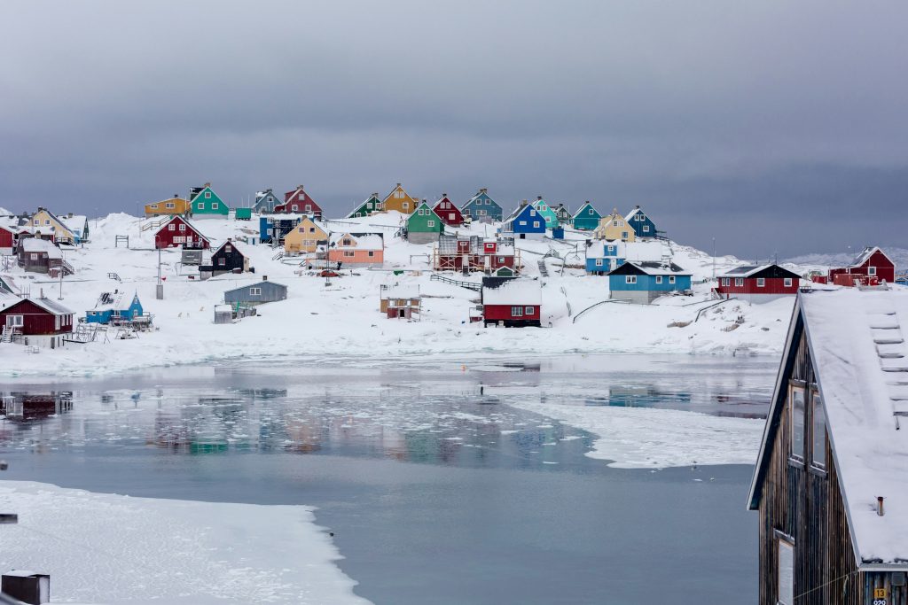colorful homes decorate the snowy backdrop of Greenland