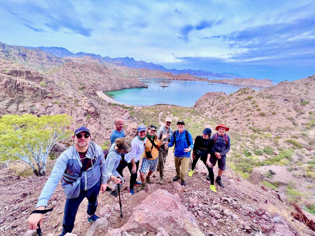 group of people on top of an island hill