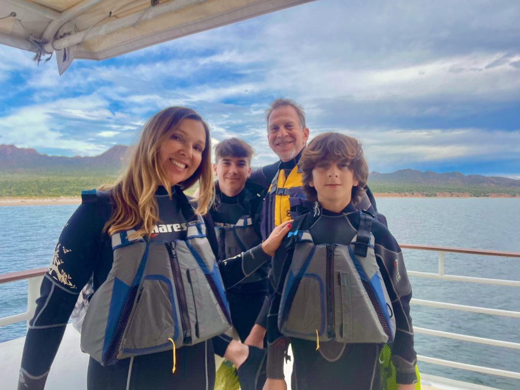 family in wetsuits and lifejackets on cruise to Baja Mexico