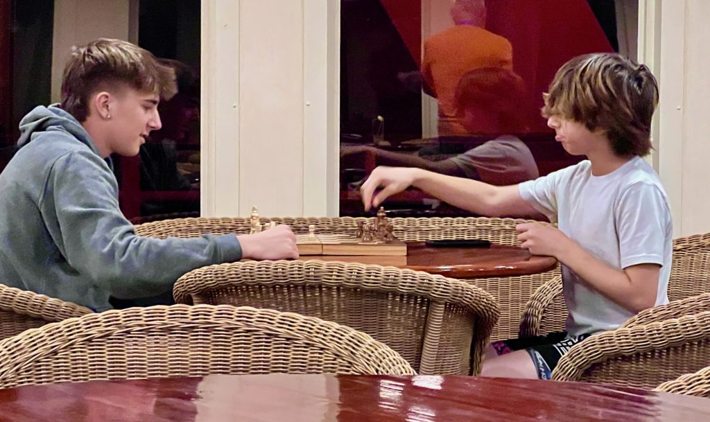 teens playing chess on cruise to baja mexico