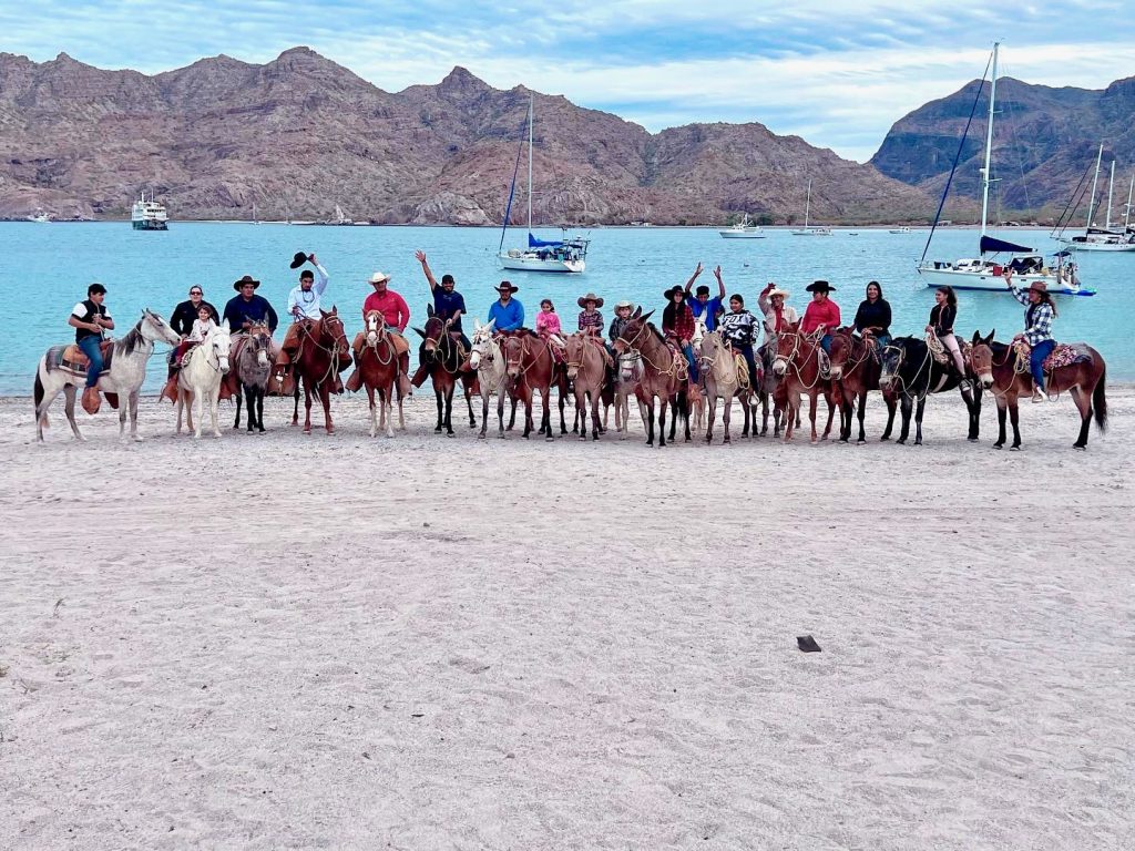 Line of family on horseback against the ocean