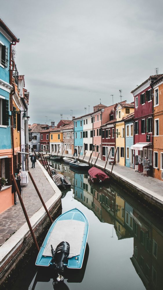 boat in canal between houses