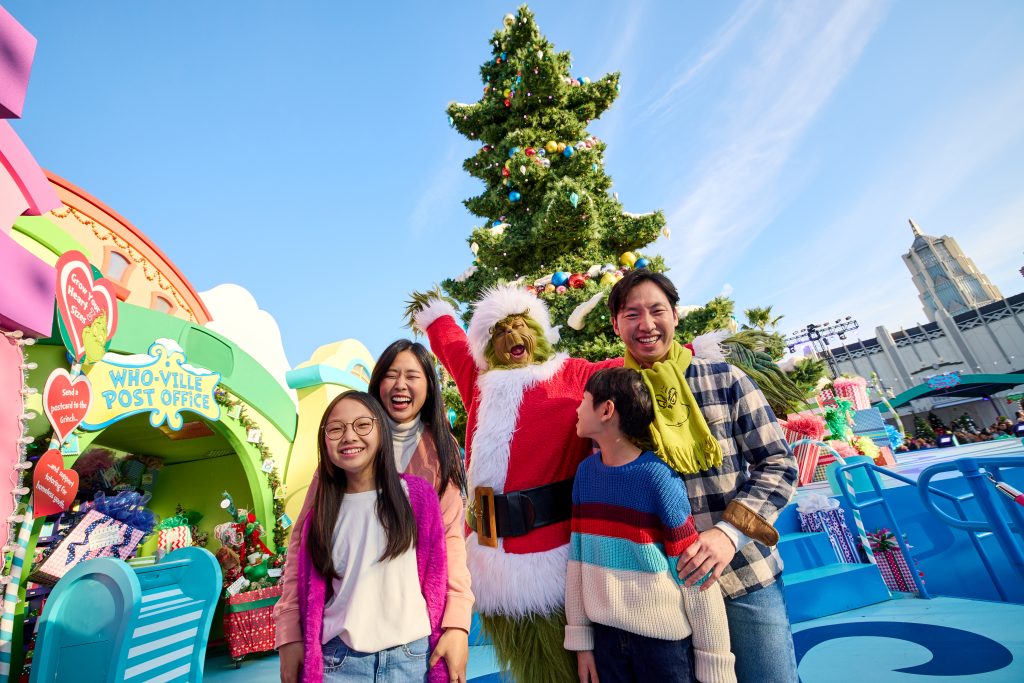 family posing with the Grinch for xmas photo