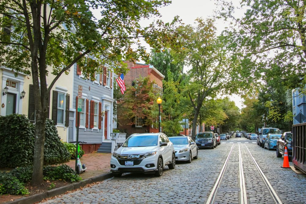 Quaint neighborhood with pavers and tracks.