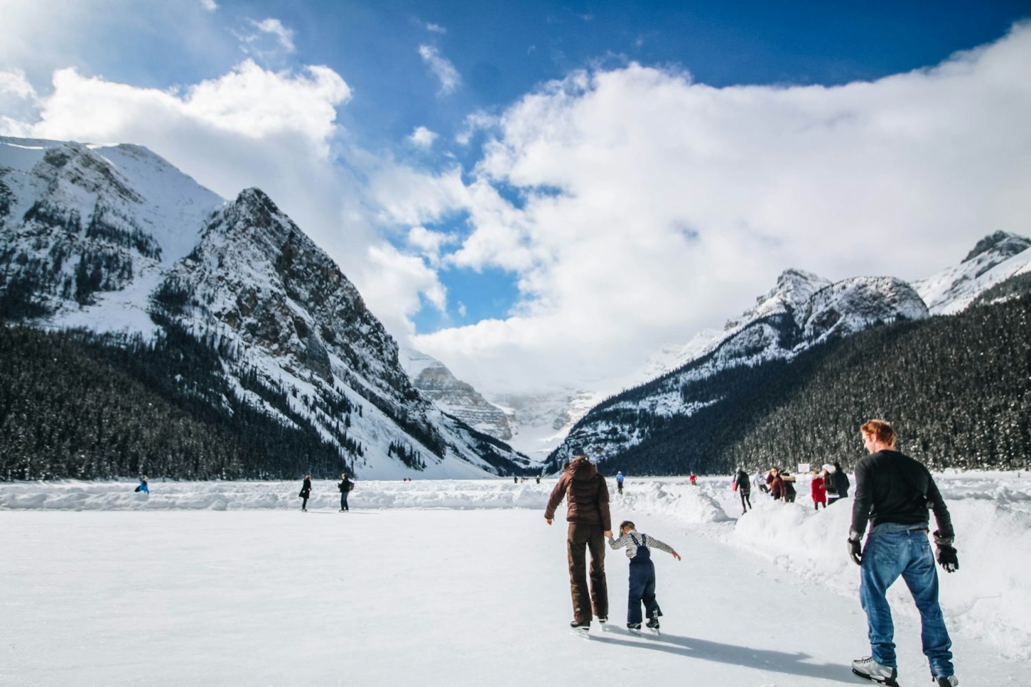 Adult and child ice skating. Colorado Ski Towns.