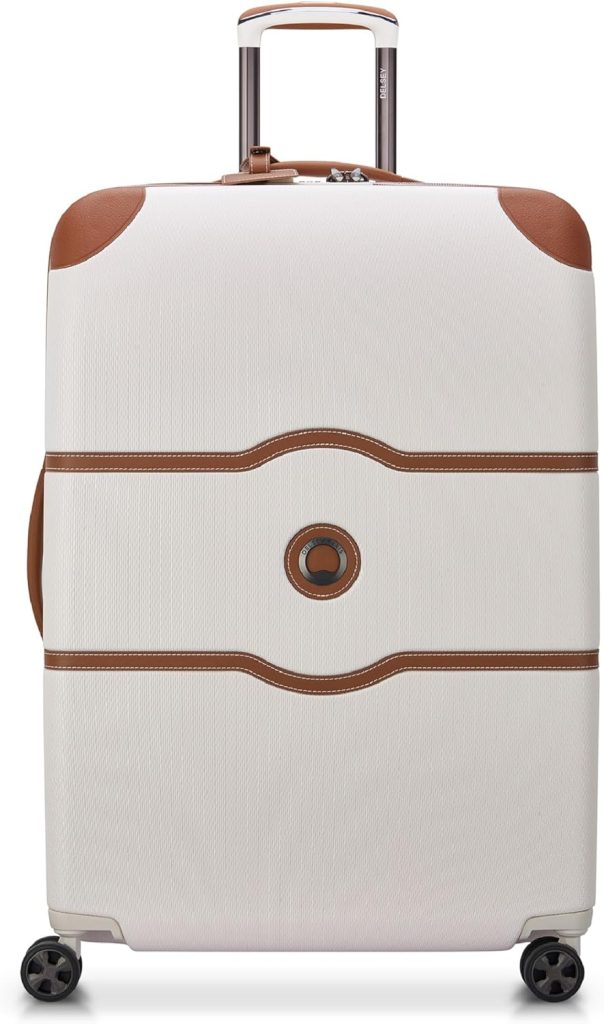 white suitcase with brown leather trim