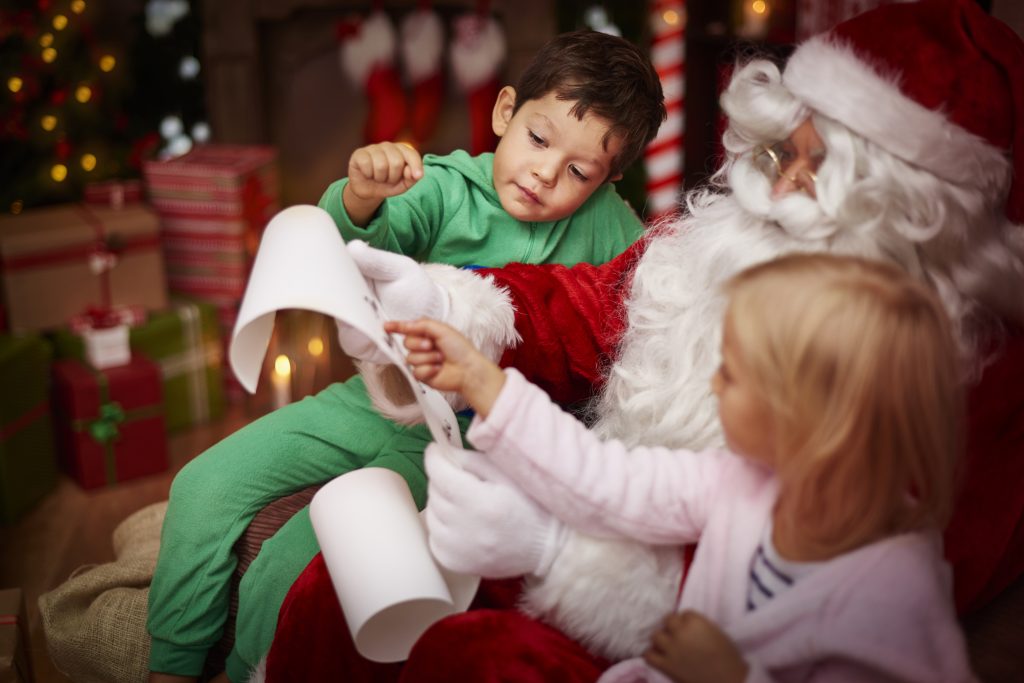 santa sitting with two kids