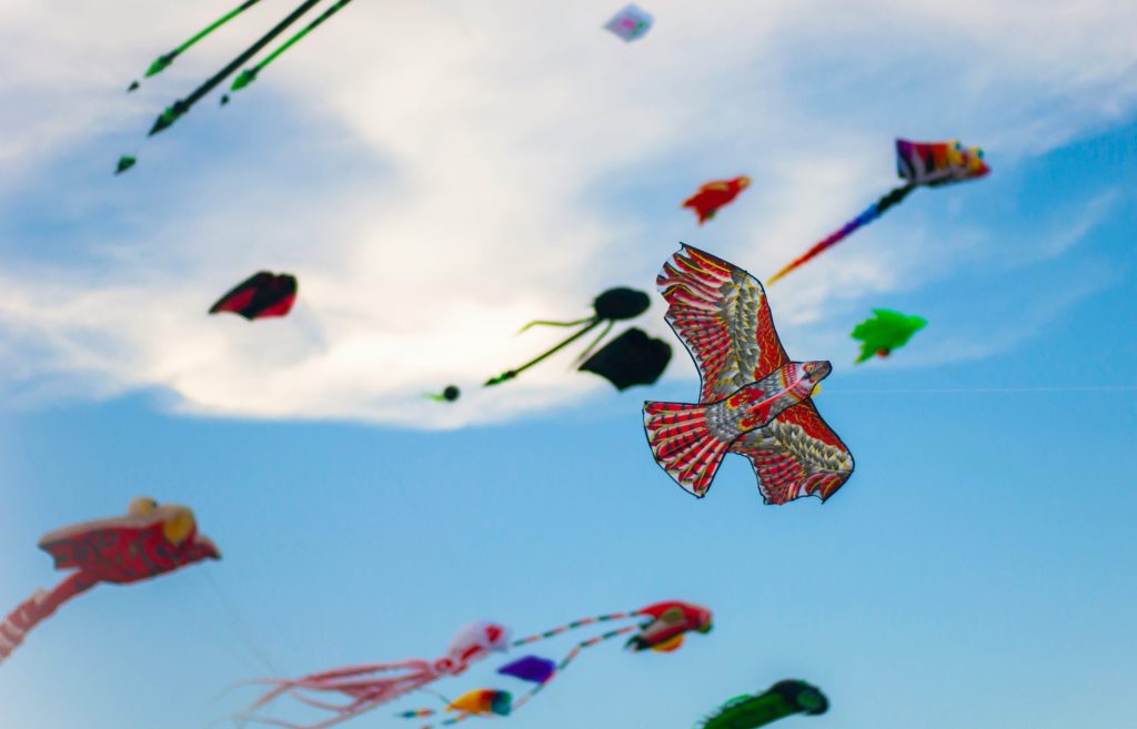 Multiple kites flying in the sky. 