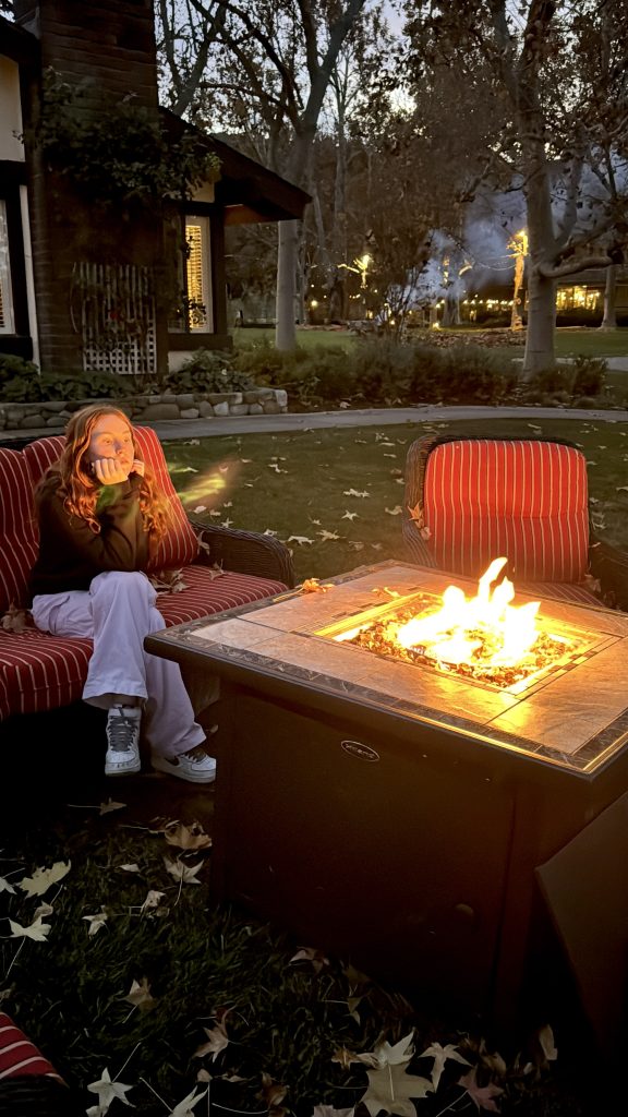 Girl relaxing by the campfire at Alisal Ranch.