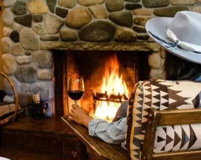 Relaxing by the fire with a glass of wine after a day of family fun at Alisal Ranch.