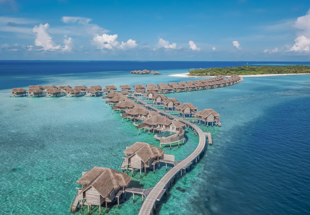 overwater bungalows in baby blue water