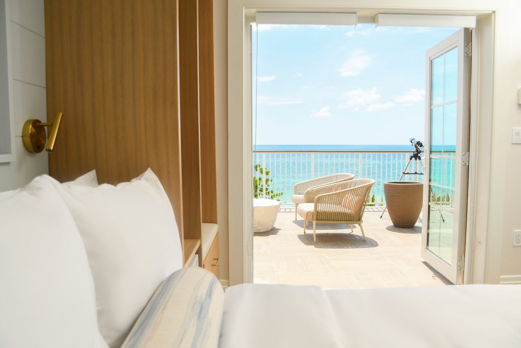 door in hotel room opening to blue tropical water