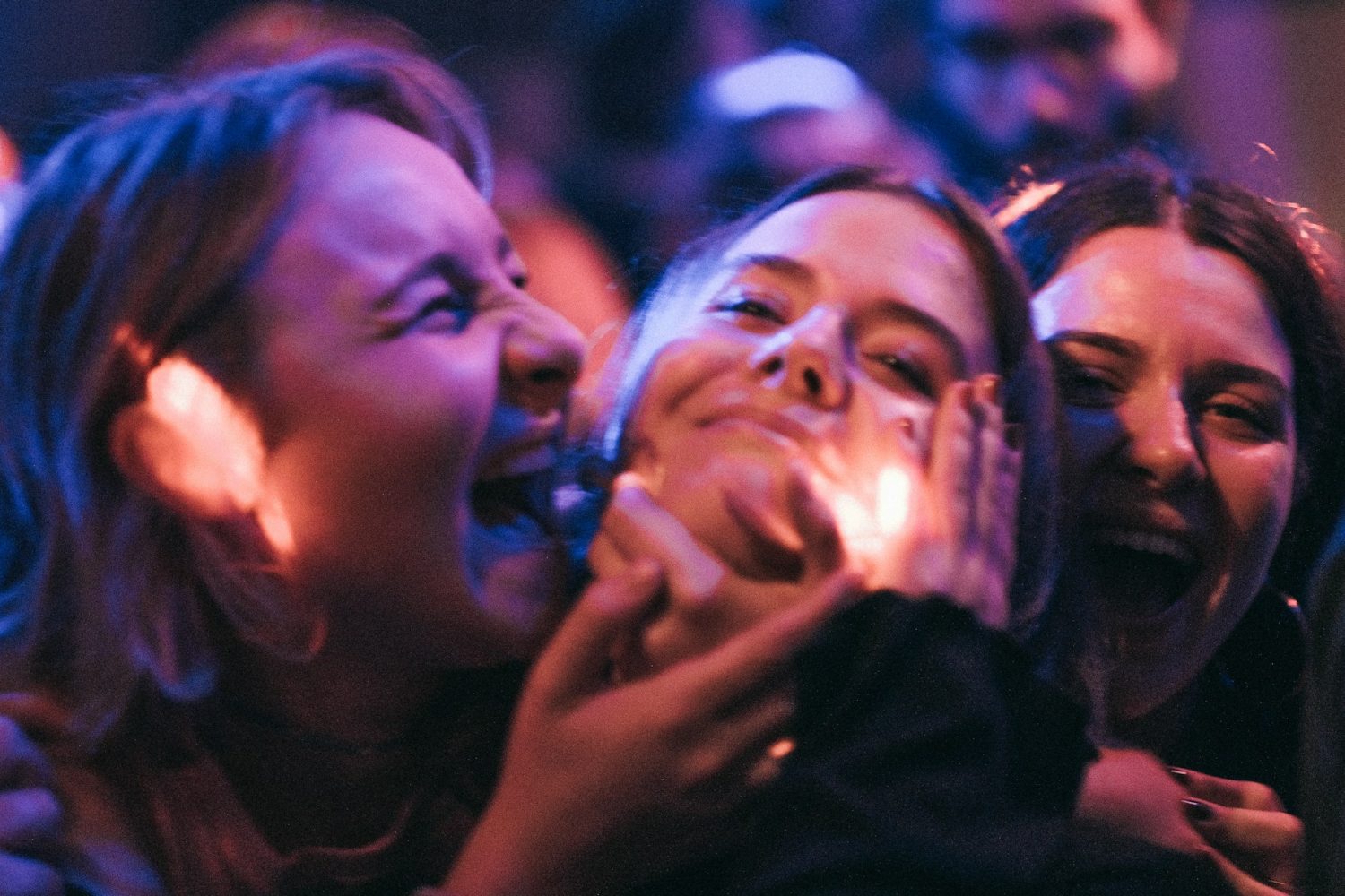 People laughing together at a show. St. Patrick's Day in New York City.