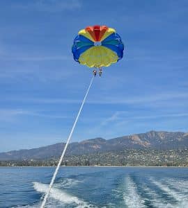 A family parasailing on a beautiful day in Santa Barbara.