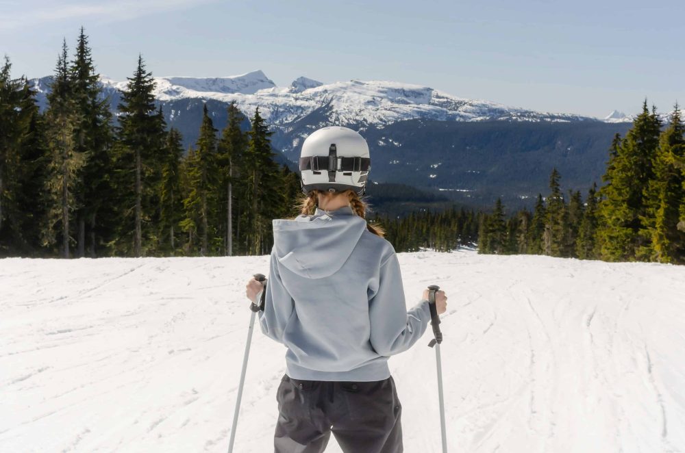 woman on skis looking down mountain