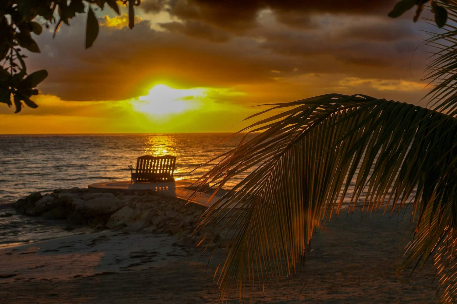 View of a two beach chairs facing an incredible Jamaican sunset. Best hotels in Jamaica for families. 
