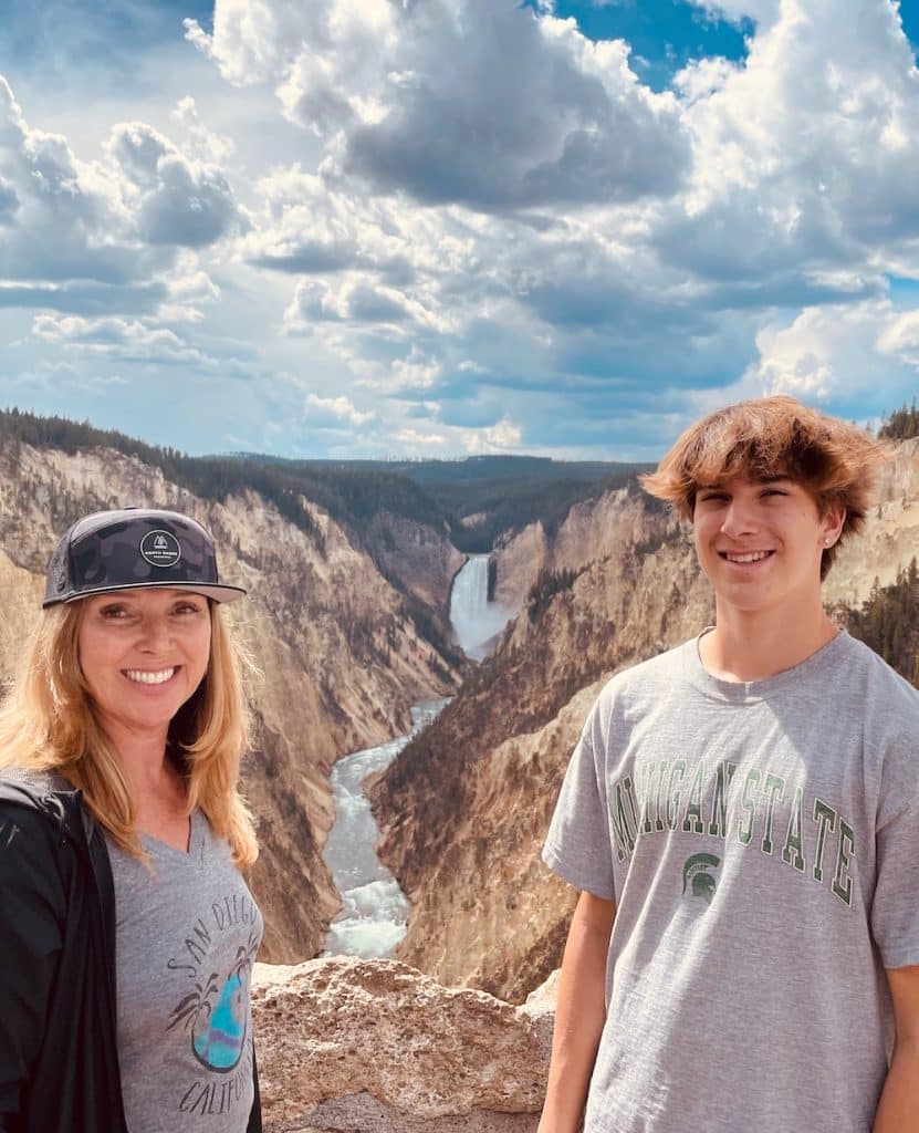 author and son in front of canyon with waterfall