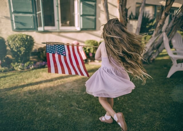 girl twirling holding american flag