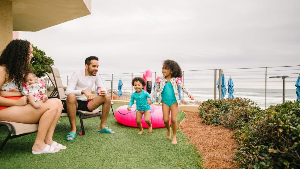 family on lawn overlooking ocean