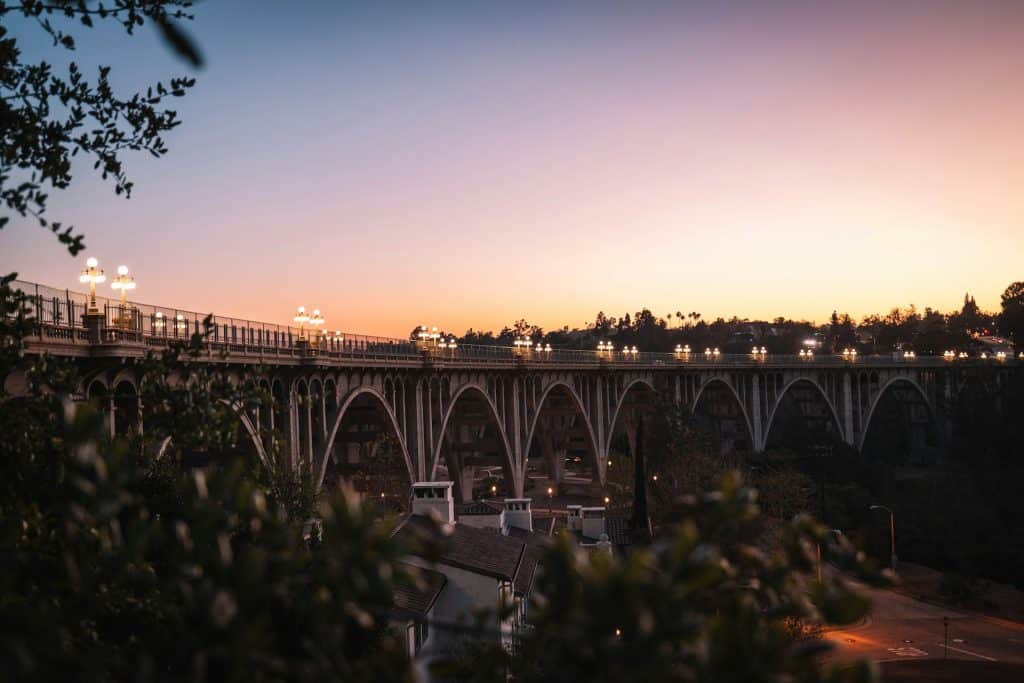 bridge at sunset with cars driving over