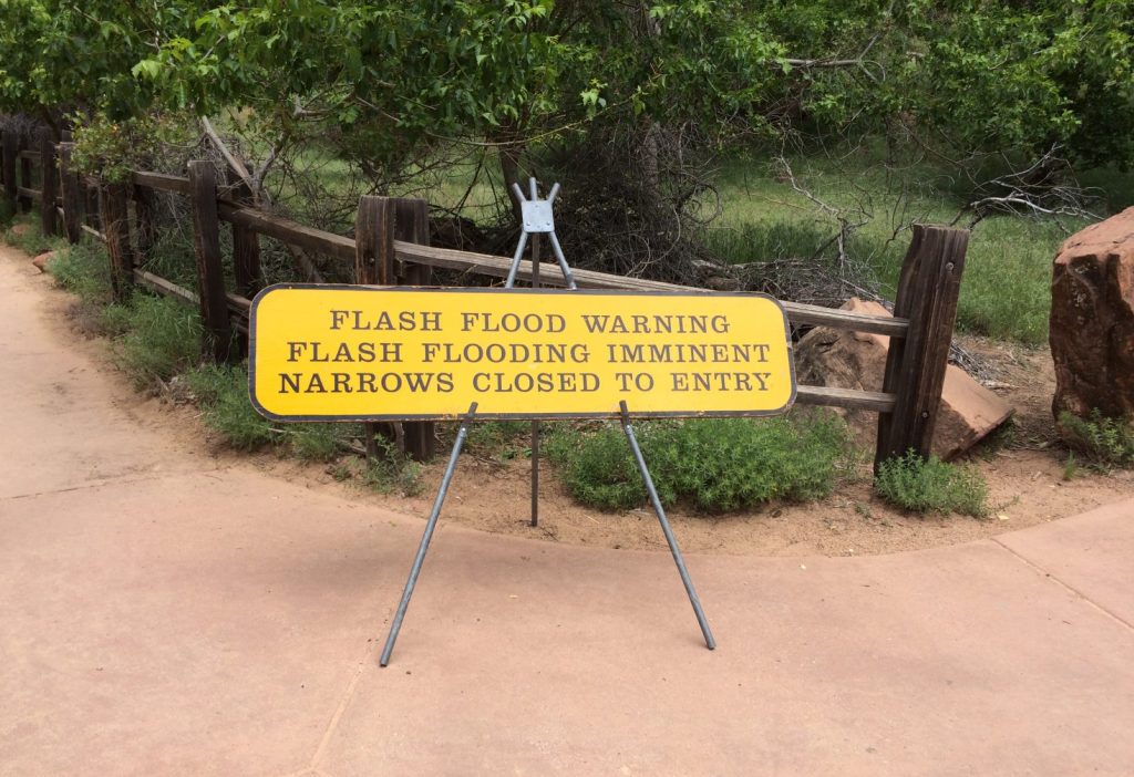 A warning sign notifying visitors that a trail is closed. 