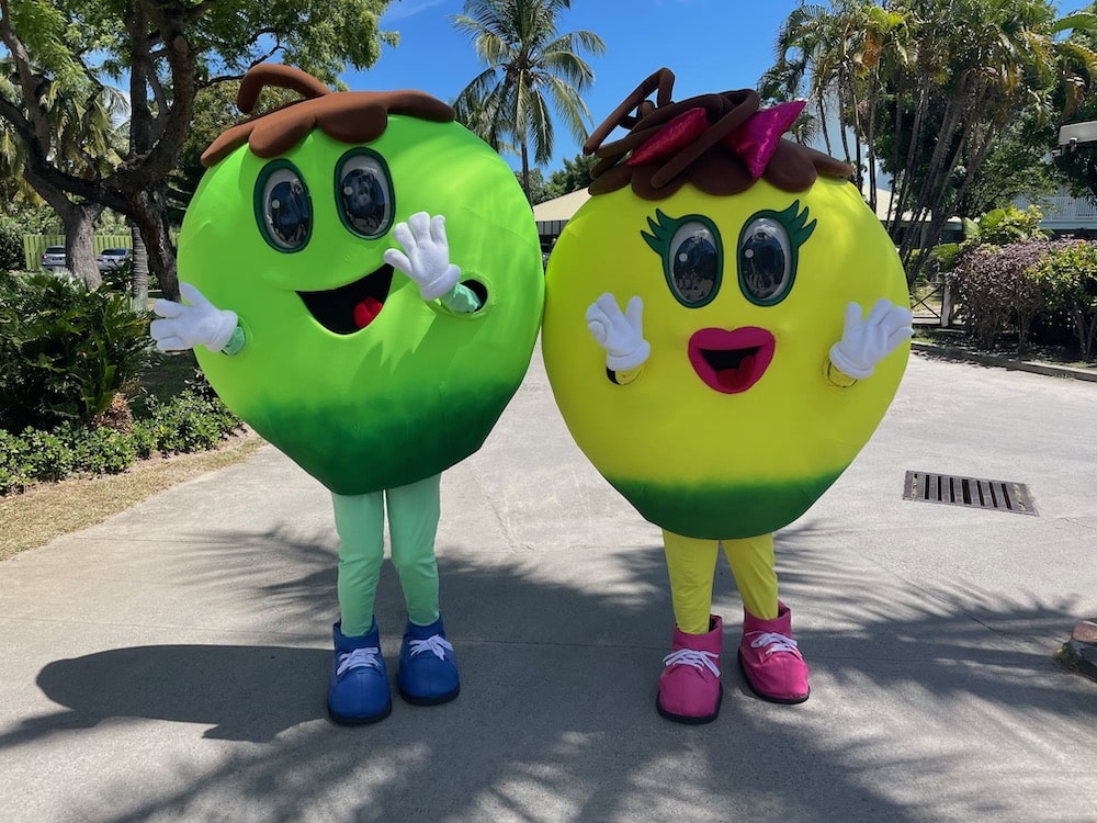 people in green and yellow round happy face costumes