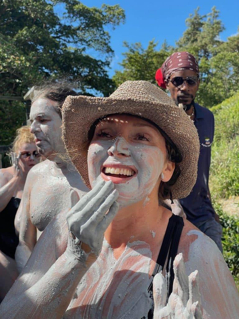woman putting mud on face