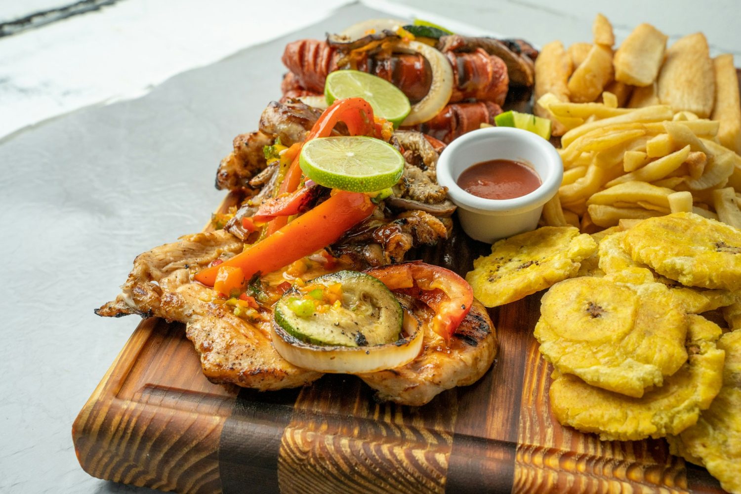 Carribean foods on a wooden platter. Best beaches in Antigua. 