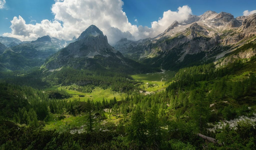 green mountain with clouds overhead