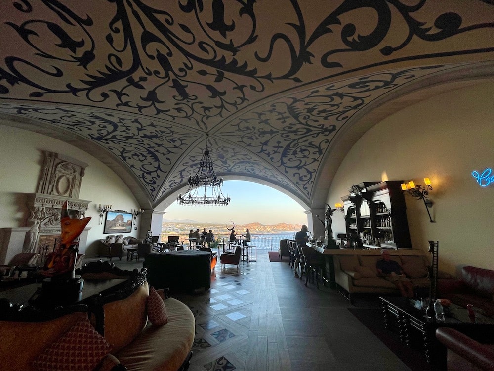 ornate hotel lobby with painted ceilings and ocean view