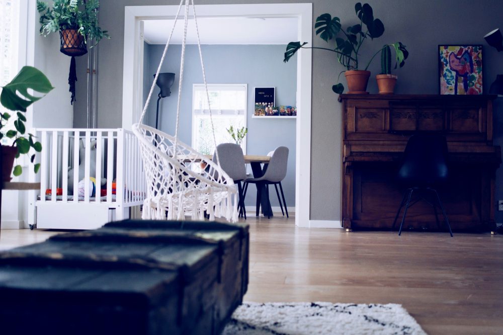 living room with pack and play and swing