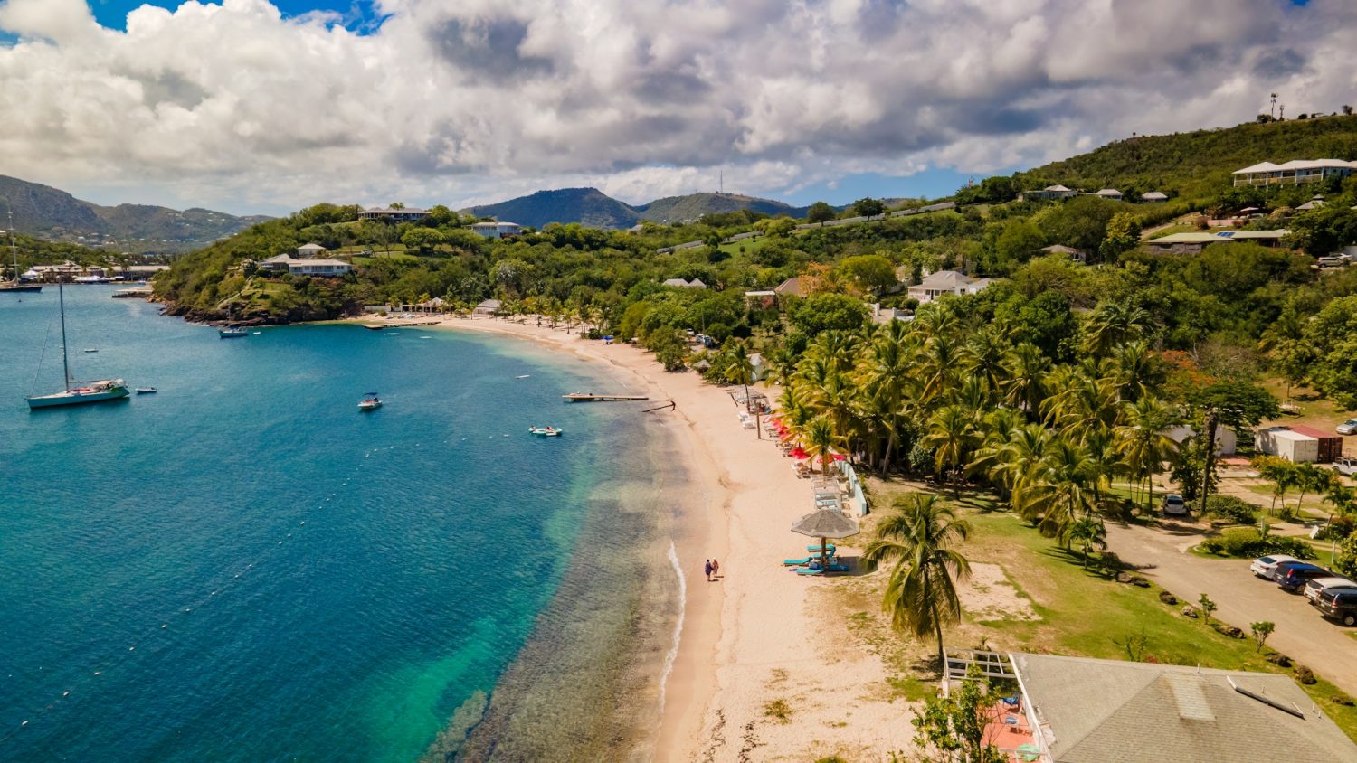Blue coastline and lush greenery in Antigua. Baby-friendly Caribbean resorts.
