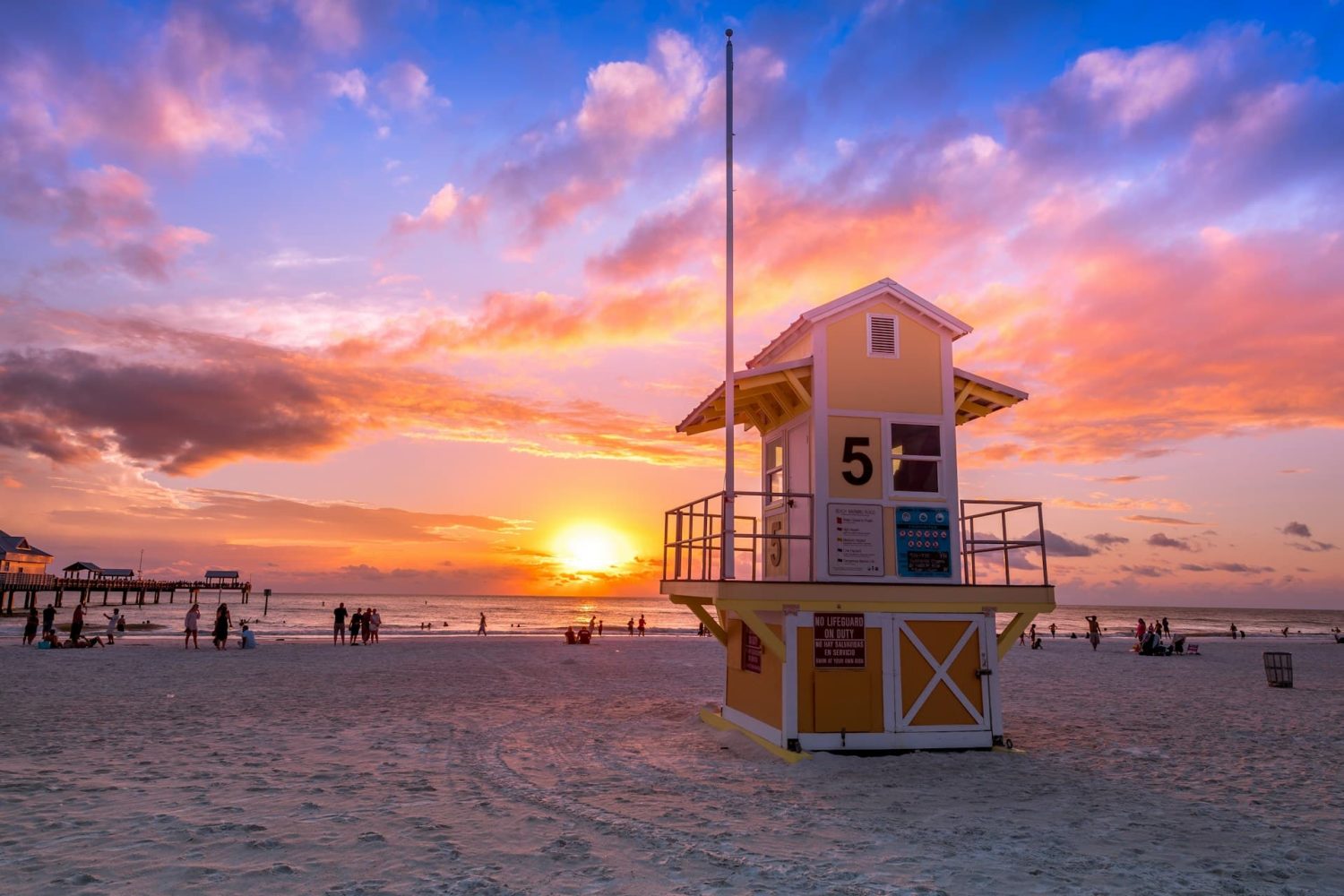 Sunset and lifeguard house on Clearwater Beach, FL. Cheap beach trips.