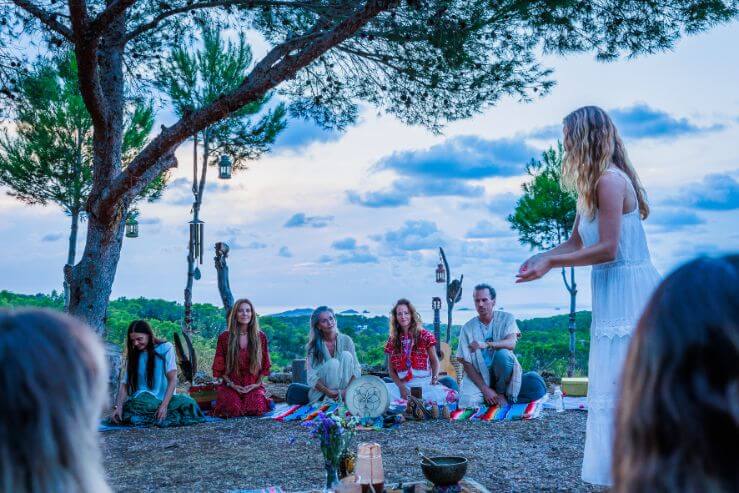 people sitting in meditation outdoors
