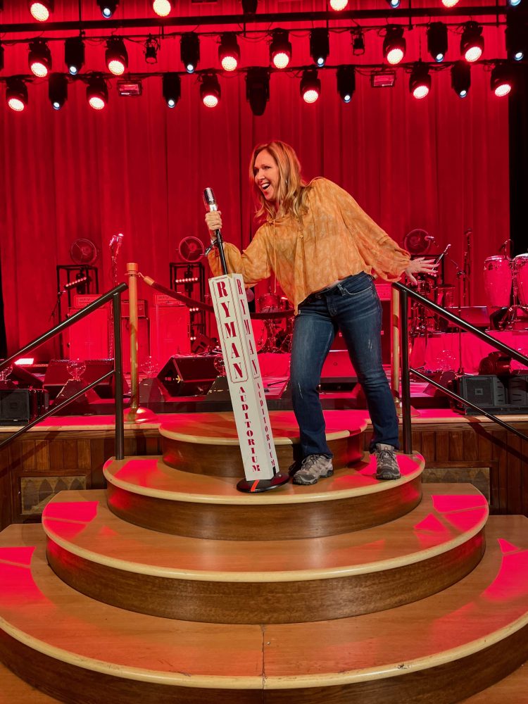 woman on stage at Ryman Auditorium