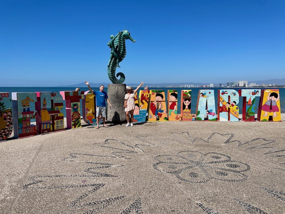 couple in front of Puerto Vallarta sign