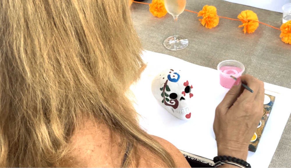 author over a plaster skull with paints