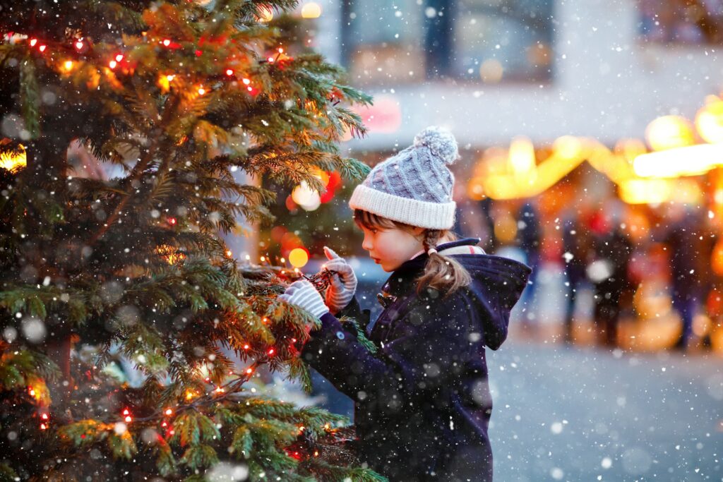 girl by christmas tree