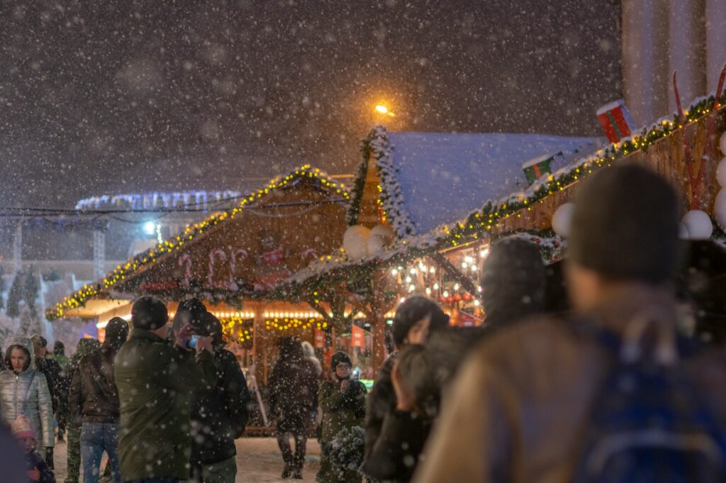 snow falling at xmas market