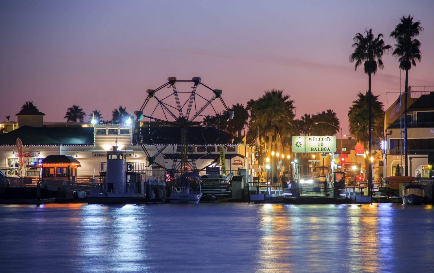 Balboa Island lit up at night, view of the Ferris wheel. Best beaches in Orange County, CA.