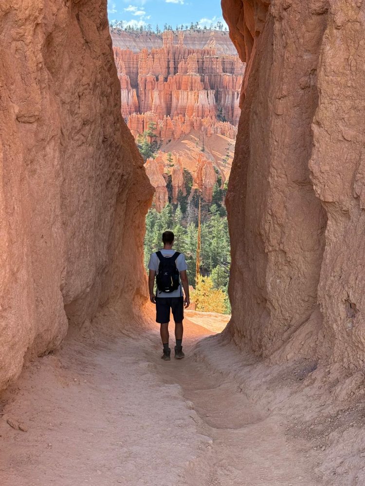 A man standing between canyon walls. Top things to do in Bryce Canyon National Park.