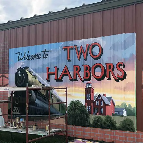 Artsy sign that says "Welcome to Two Harbors". Grand Marais with kids. 