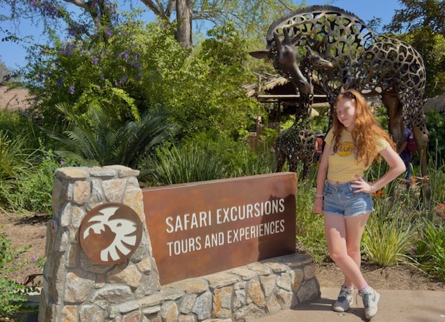 Cute girl on a safari tour to see wild animals!