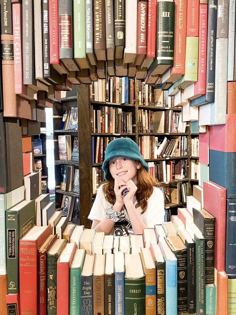 The Last Bookstore is a unique LA experience, as girl puts head through window of books. 