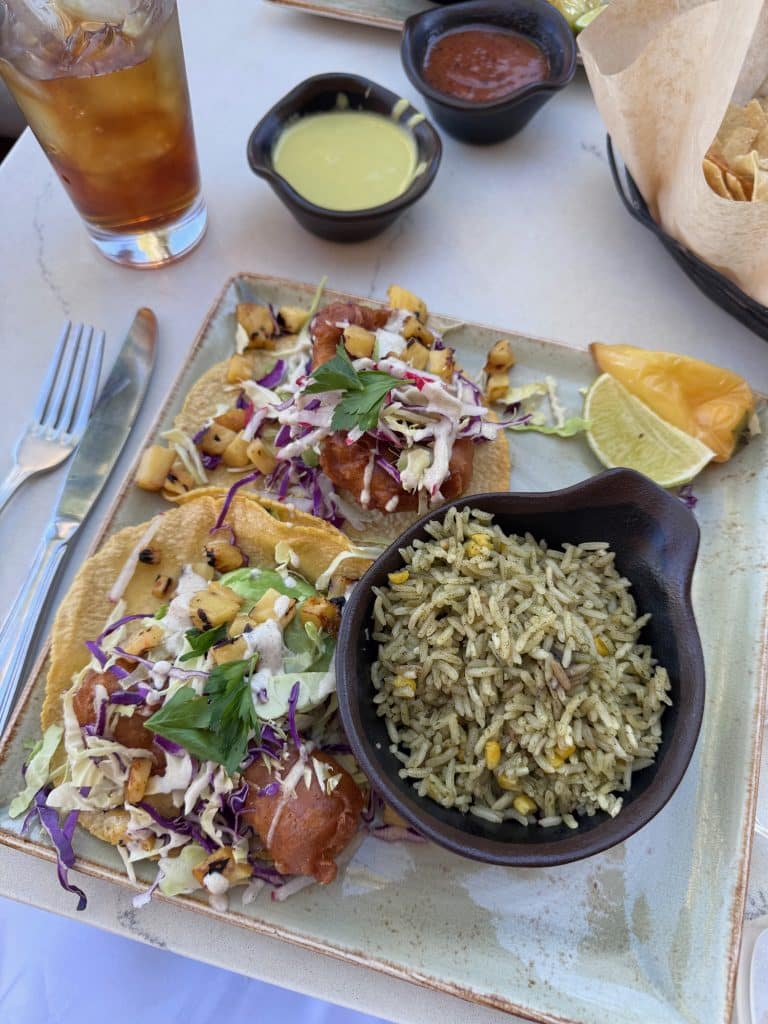 Table at Flor de Maíz with Oaxacan-inspired dishes, fresh tortillas, and cocktails on an outdoor patio overlooking East Beach, Stearns Wharf, and the Santa Barbara coastline.