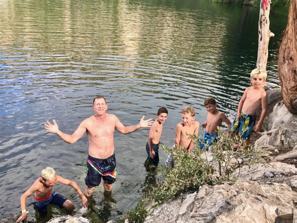 boys and man in lake